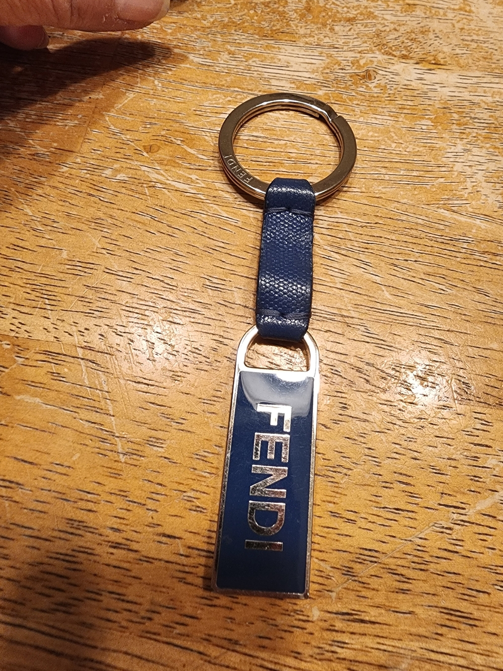 blue leather Fendi logo plaque keychain features silver-tone hardware